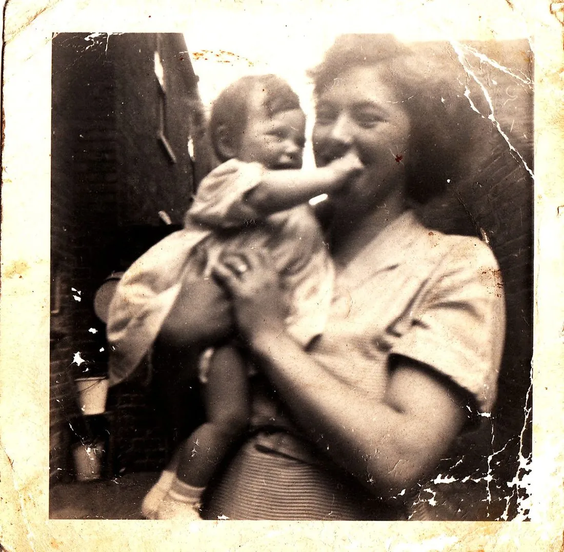 Old family photograph of Sandra, the 'Nanny' behind Nana Sans, smiling as she holds a baby